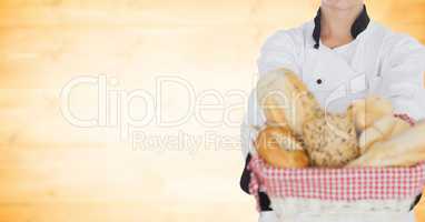 Chef with bread against blurry yellow wood panel