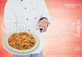 Chef with pizza against blurry red wood panel
