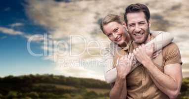 Couple smiling against sky and hills