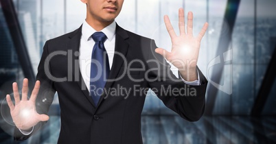 Business man mid section with flares on hands against blurry window