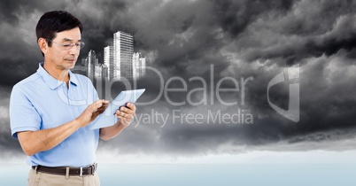 Man with tablet and white building graphic against stormy sky
