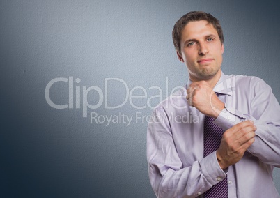 Man in lavender shirt holding arm against navy background