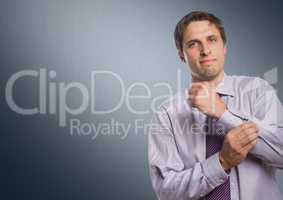 Man in lavender shirt holding arm against navy background