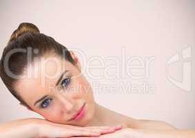 Woman leaning on hands against pink background