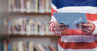 Woman holding tablet in Library