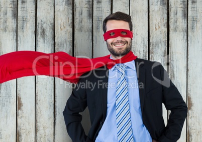 Superhero businessman against wood