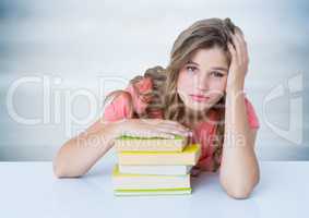 Woman with books at desk against blurry grey wood panel