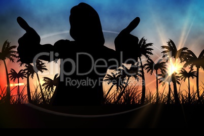 Silhouettes of lady showing thumbs up  against sunset view with palm trees