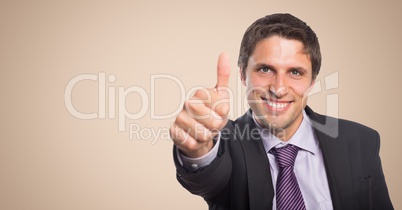 Business man thumbs up against cream background