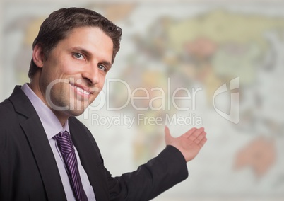 Business man gesturing towards blurry map
