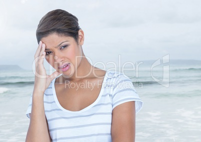 Stressed woman headache in front of sea