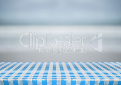 Picnic table against blurry beach