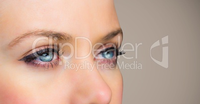 Close up of woman's eyes against brown background