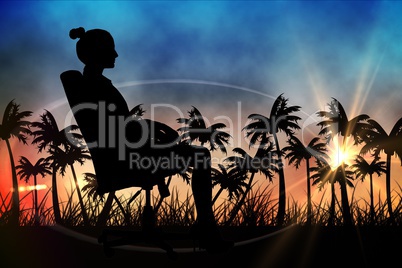 Silhouettes of lady sitting in office chair against sunset view with palm trees