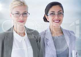 Two business women with flare against blurry grey wood panel