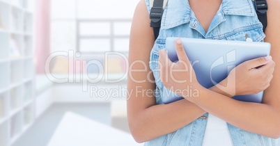 Woman holding tablet in Library