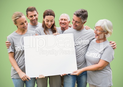 Volunteers with large blank card against green background