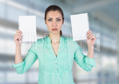 Sad woman holding ripped apart paper against blurred blue background