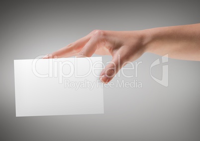 Hand with blank card against grey background