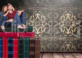 Couple sitting on Books stacked by wallpaper antique decorative
