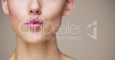 Close up of puckered lips against brown background