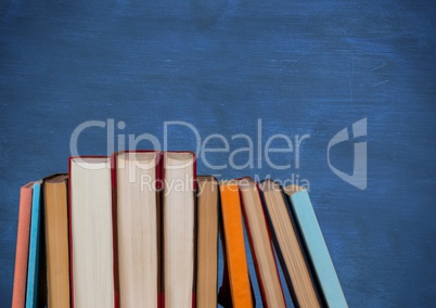 Standing books against blue chalkboard