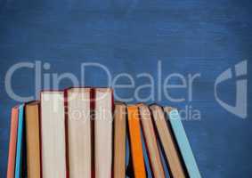 Standing books against blue chalkboard