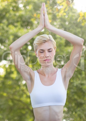 Woman doing yoga Meditating by trees