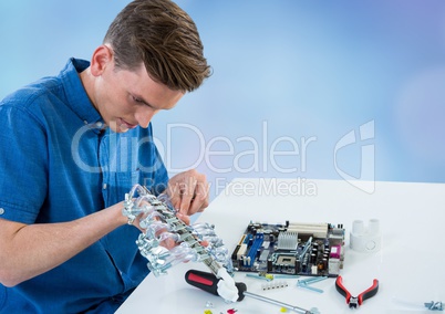 Man with electronics against blue blurry background