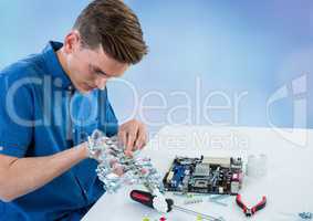 Man with electronics against blue blurry background