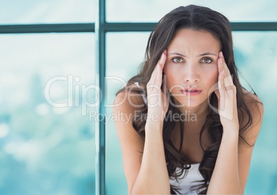 Stressed worried woman against window