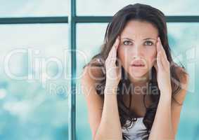 Stressed worried woman against window