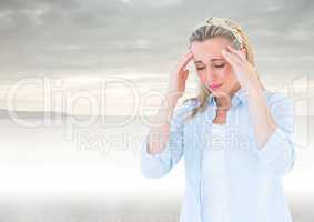 Stressed woman headache in front of sea