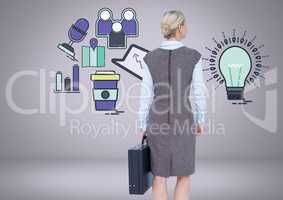 Businesswoman looking at lightbulb and business graphic drawings