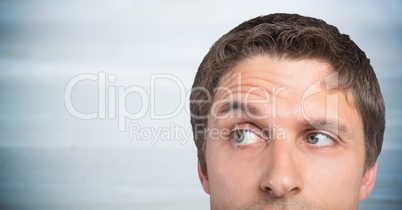 Top of man's head against blurry grey wood panel