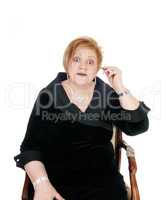Senior woman putting hearing aid on.