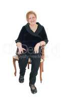 Senior woman relaxing in armchair.