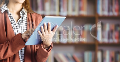 Womans hands on tablet in Library