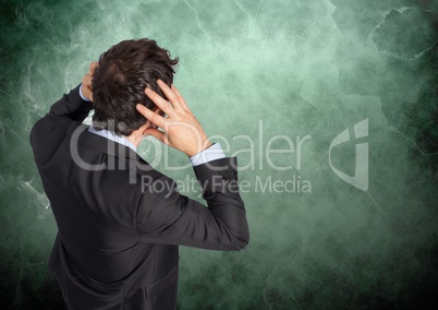 Stressed man against green background with smoke