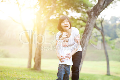 Asian mother and son playing at outdoors.