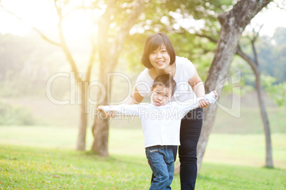 Mother and son playing outdoor.