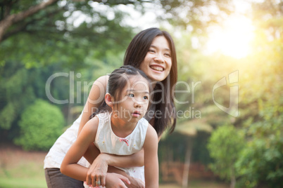 Mother and daughter playing at outdoors.