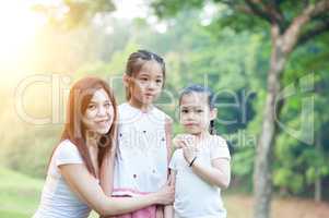 Mother and daughters portrait at outdoors.