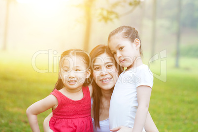 Mother and daughters in the nature.