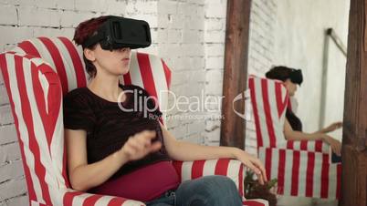 Woman playing game in virtual reality glasses