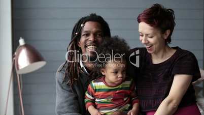 Portrait of happy diverse family with son at home