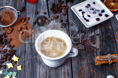 Cup of hot black coffee on a gray wooden surface