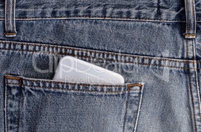 Smartphone in the back pocket of blue jeans