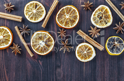 Circles of dried orange on a brown wooden surface