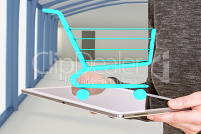 Woman holds tablet pc with shopping cart